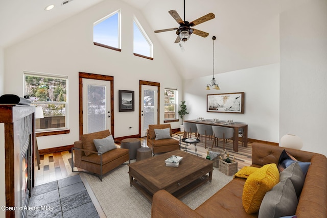 living room featuring ceiling fan, high vaulted ceiling, and light wood-type flooring