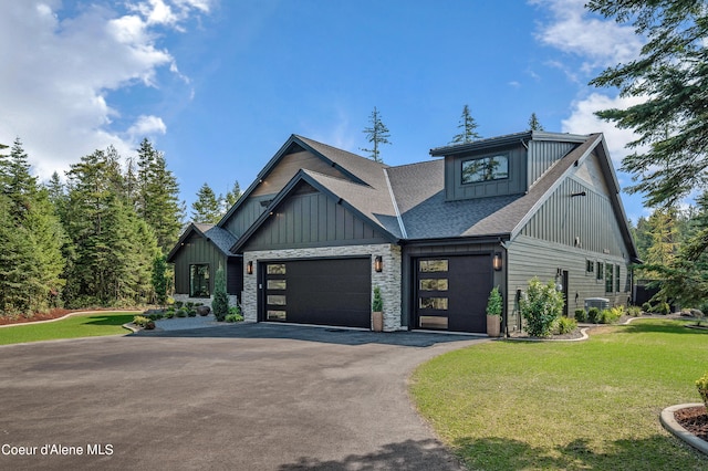 craftsman-style home featuring a garage and a front lawn