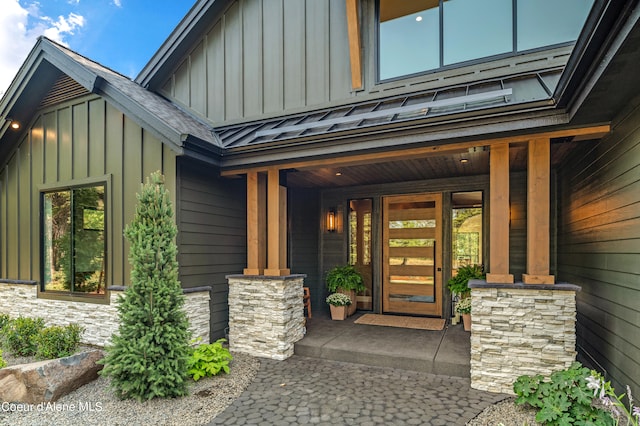 view of exterior entry with a porch