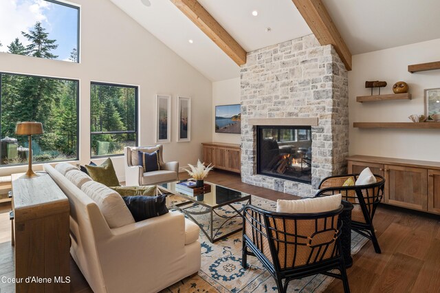 living room with high vaulted ceiling, dark hardwood / wood-style floors, beamed ceiling, and a stone fireplace