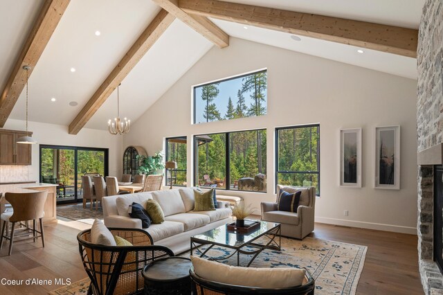 living room with a fireplace, beamed ceiling, and high vaulted ceiling