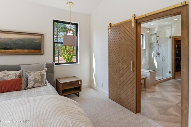 bedroom with a barn door and ensuite bath