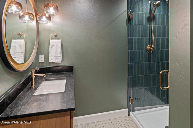 bathroom with vanity, an enclosed shower, and tile patterned floors