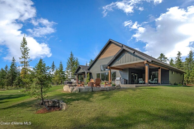 rear view of property with a patio area and a lawn