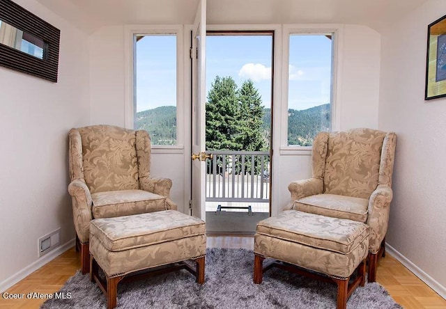 sitting room featuring a mountain view and light parquet flooring