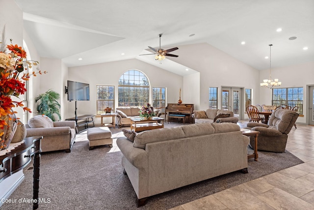 living room featuring french doors, high vaulted ceiling, light tile floors, and ceiling fan with notable chandelier