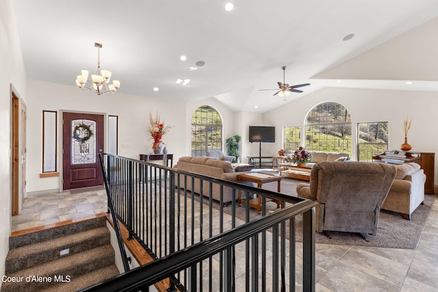 interior space with light tile flooring, a healthy amount of sunlight, vaulted ceiling, and a notable chandelier