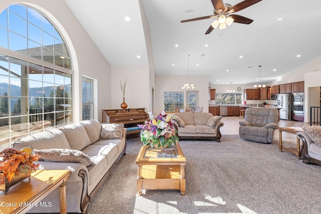 living room featuring carpet, high vaulted ceiling, sink, and ceiling fan with notable chandelier