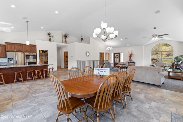 dining area with light tile floors, high vaulted ceiling, and ceiling fan with notable chandelier