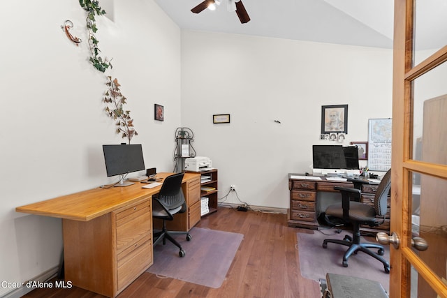 home office featuring vaulted ceiling, ceiling fan, and dark hardwood / wood-style floors