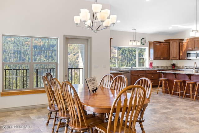 dining area featuring sink, a chandelier, and light tile flooring