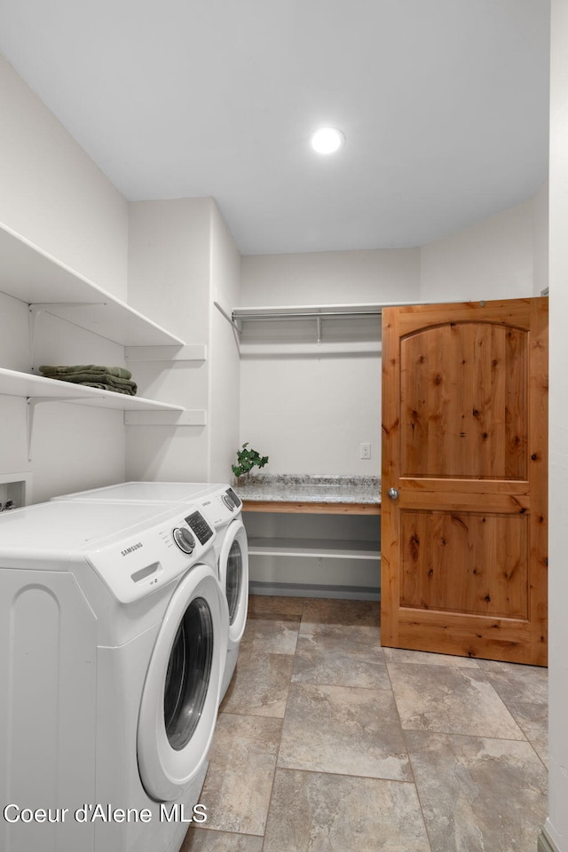 laundry area featuring independent washer and dryer, light tile floors, and hookup for a washing machine