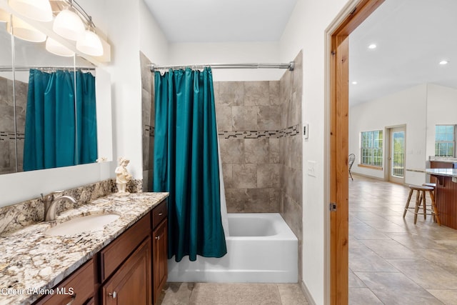 bathroom featuring tile flooring, shower / bath combo, and vanity