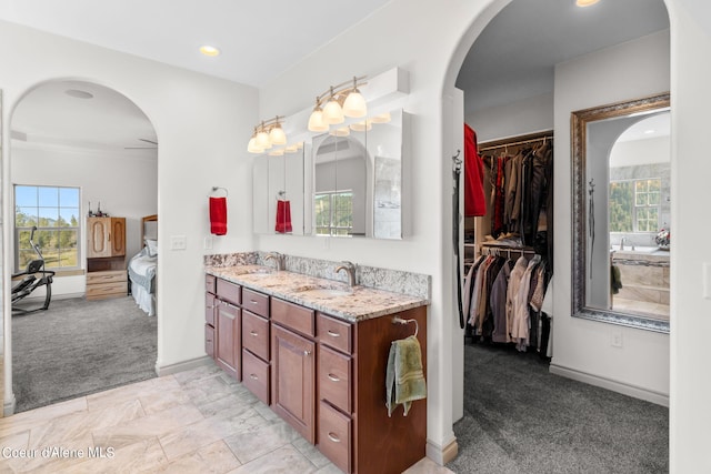 bathroom featuring plenty of natural light, dual vanity, and tile flooring