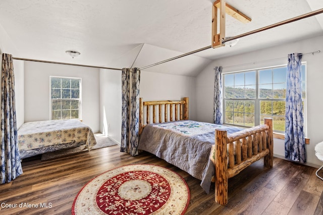 bedroom featuring lofted ceiling, a textured ceiling, and dark hardwood / wood-style floors