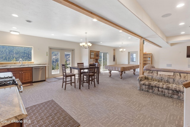 dining room featuring pool table, sink, a chandelier, french doors, and light colored carpet