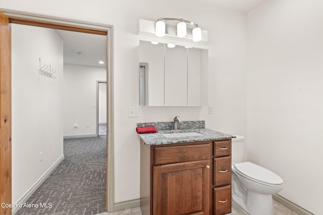 bathroom featuring toilet and vanity