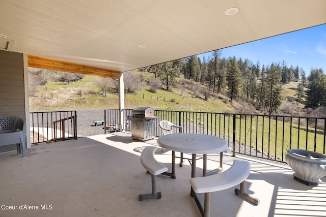 view of patio featuring a balcony and grilling area