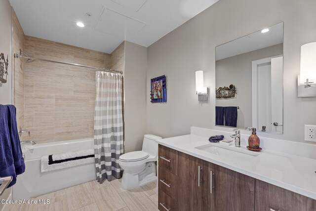 full bathroom with shower / bath combo with shower curtain, toilet, vanity, and tile floors