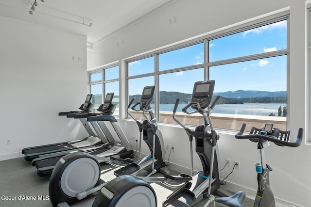 gym featuring a water and mountain view