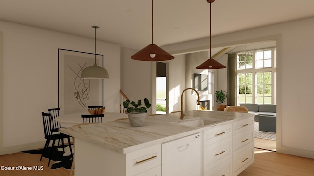 kitchen featuring light hardwood / wood-style floors, white cabinetry, an island with sink, light stone countertops, and hanging light fixtures