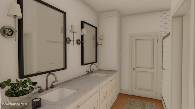 bathroom featuring hardwood / wood-style flooring and dual bowl vanity