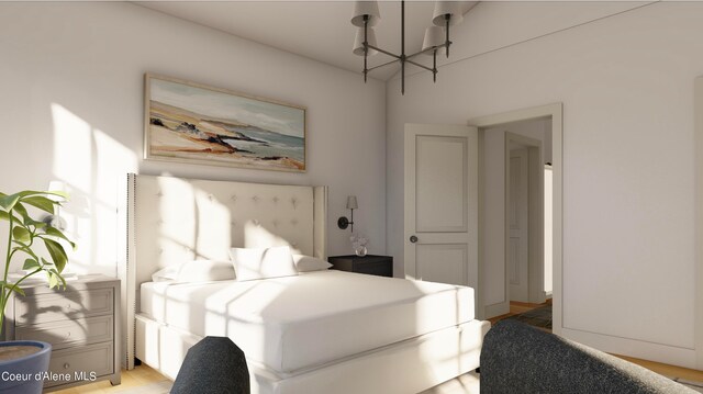 bedroom featuring an inviting chandelier and light hardwood / wood-style flooring