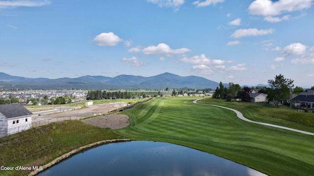 view of property's community featuring a water and mountain view and a lawn