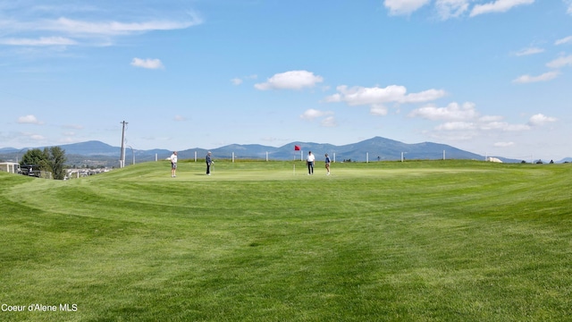 exterior space with a rural view, a lawn, and a mountain view