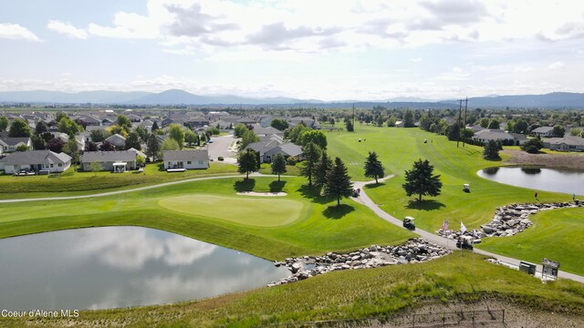 birds eye view of property with a water and mountain view