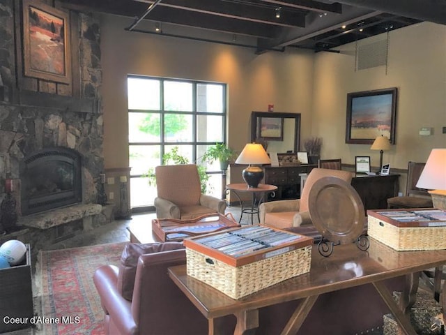 living room with a stone fireplace