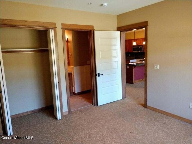 unfurnished bedroom with a closet and carpet floors