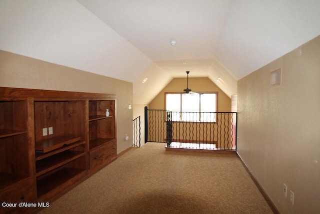 additional living space with light colored carpet, ceiling fan, and lofted ceiling