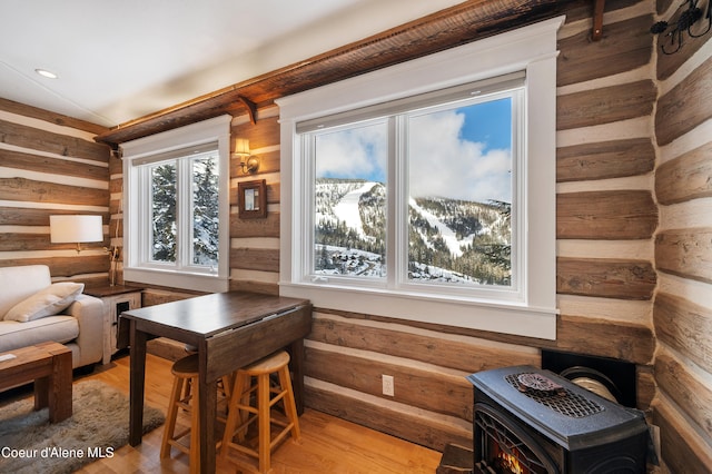 interior space featuring hardwood / wood-style floors, log walls, and a mountain view