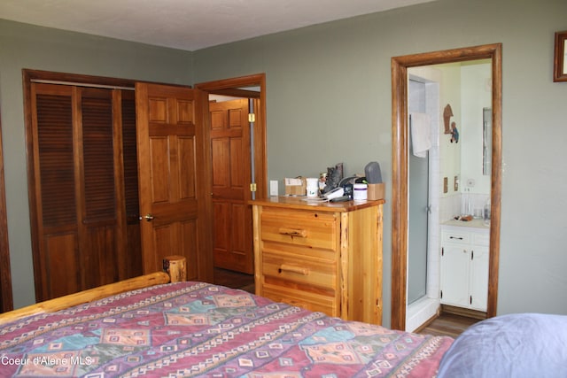 bedroom featuring a closet, dark hardwood / wood-style flooring, and connected bathroom