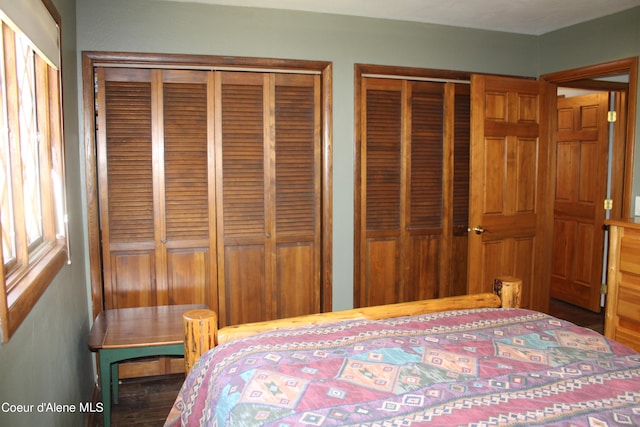 unfurnished bedroom with two closets