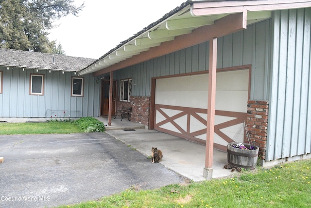 doorway to property with a garage