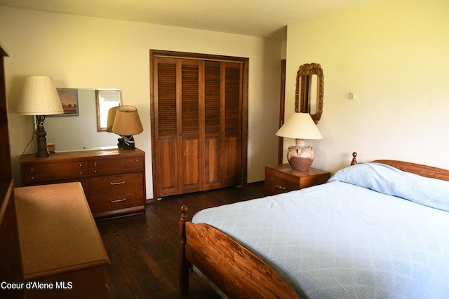 bedroom with a closet and dark hardwood / wood-style floors