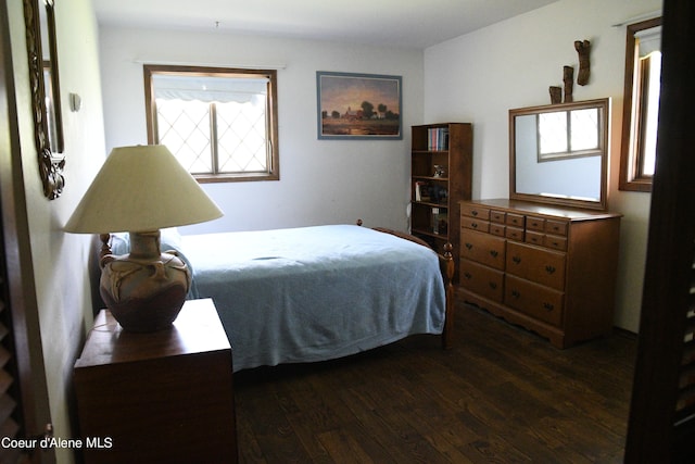 bedroom with dark wood-type flooring