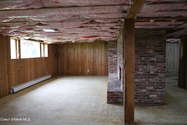 basement with brick wall and a baseboard radiator