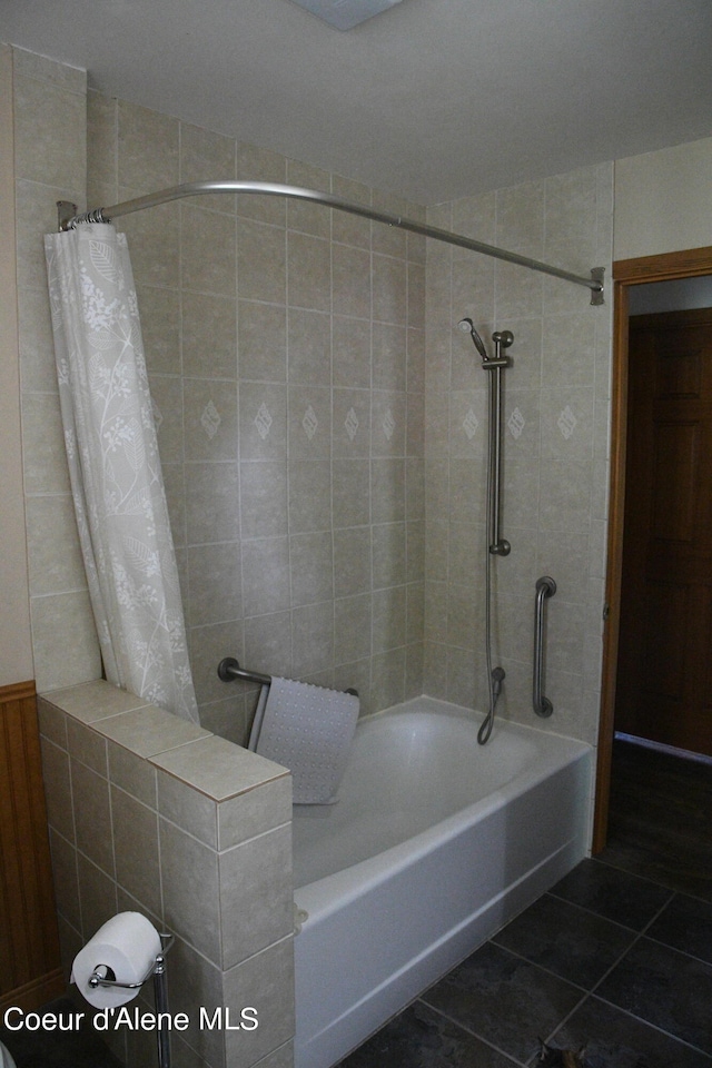 bathroom with shower / bath combination with curtain and tile flooring