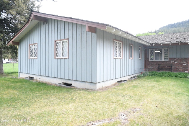 view of side of property with a yard