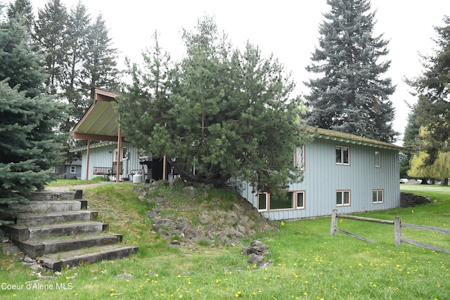 rear view of house with a yard