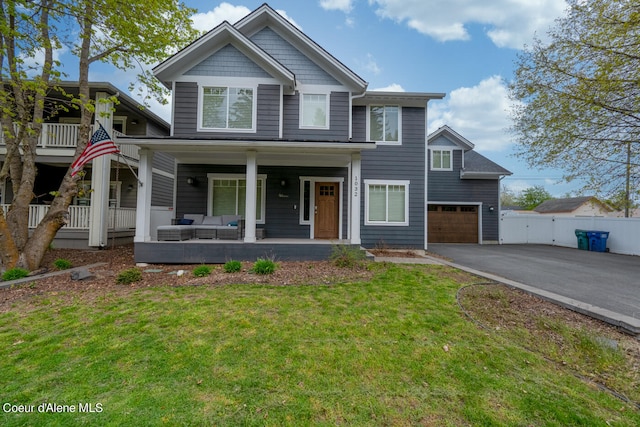 view of front facade featuring a garage, a porch, central air condition unit, and a front yard