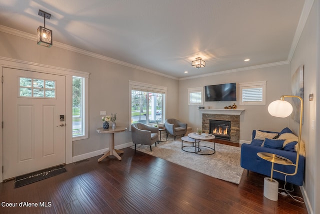 living room featuring a stone fireplace, dark wood-type flooring, and crown molding