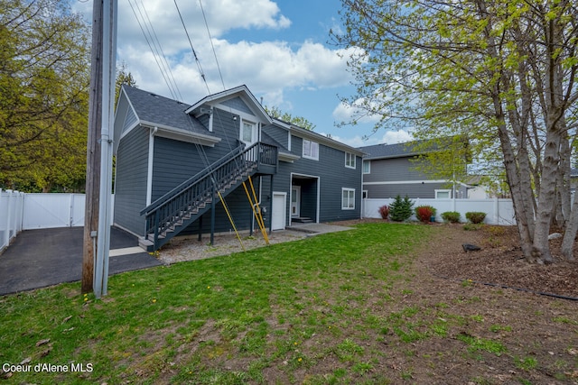 rear view of property with a patio and a yard