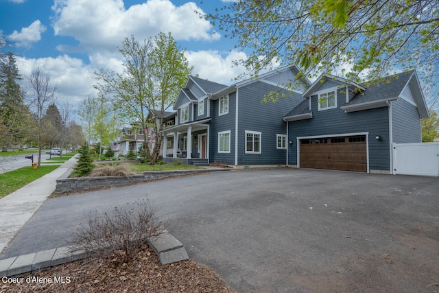 view of front of house featuring a garage and a porch