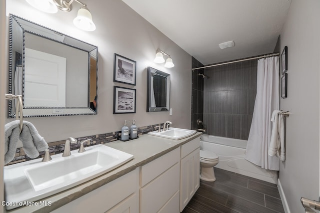 full bathroom with double vanity, toilet, tile flooring, and shower / bath combo with shower curtain