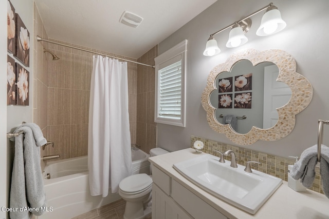 full bathroom featuring vanity, shower / bathtub combination with curtain, and toilet