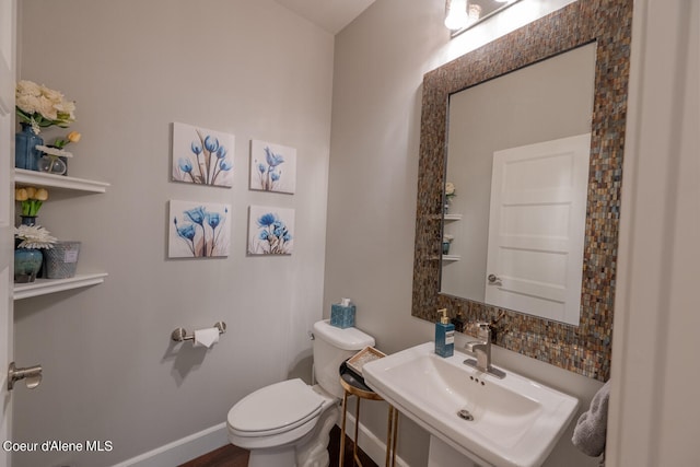 bathroom featuring toilet and sink